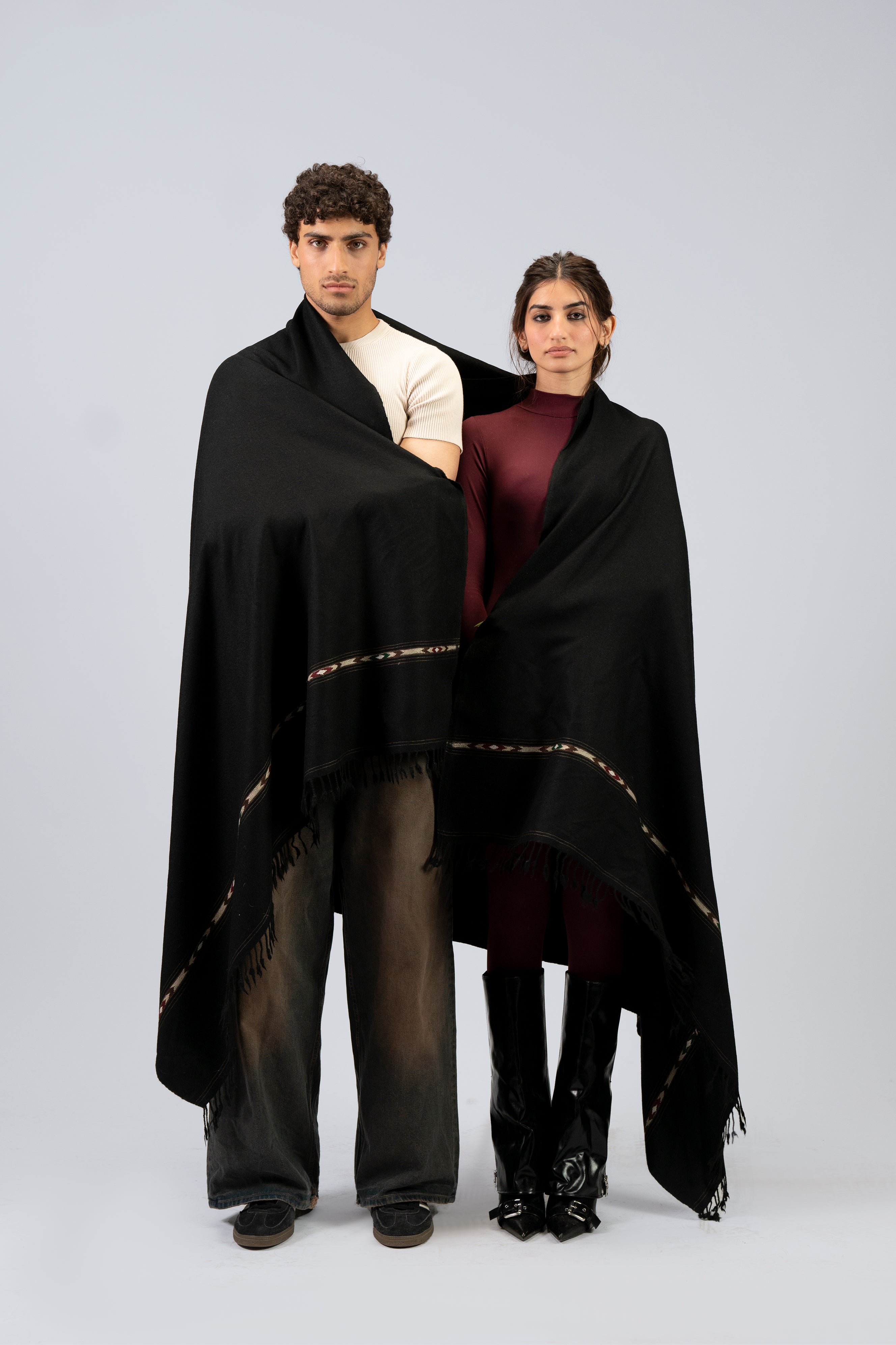 Black wool blanket scarf styled as two-person shawl wrap