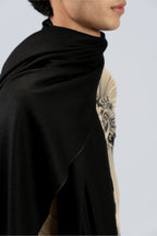 Black heavyweight lamb wool shawl close-up on male model with tattoo sleeve, side view