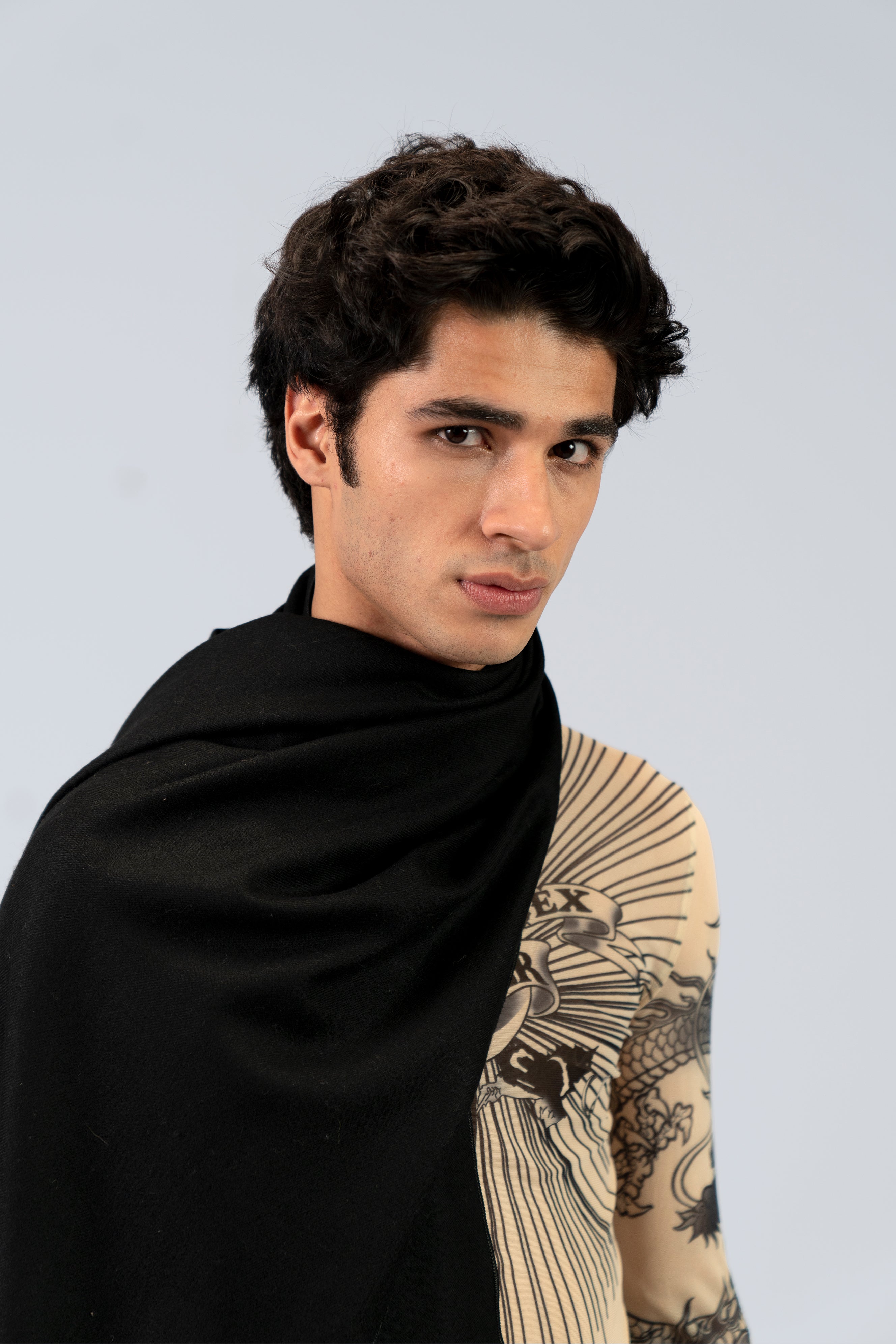 Black heavyweight lamb wool shawl close-up portrait on male model with tattoo sleeve