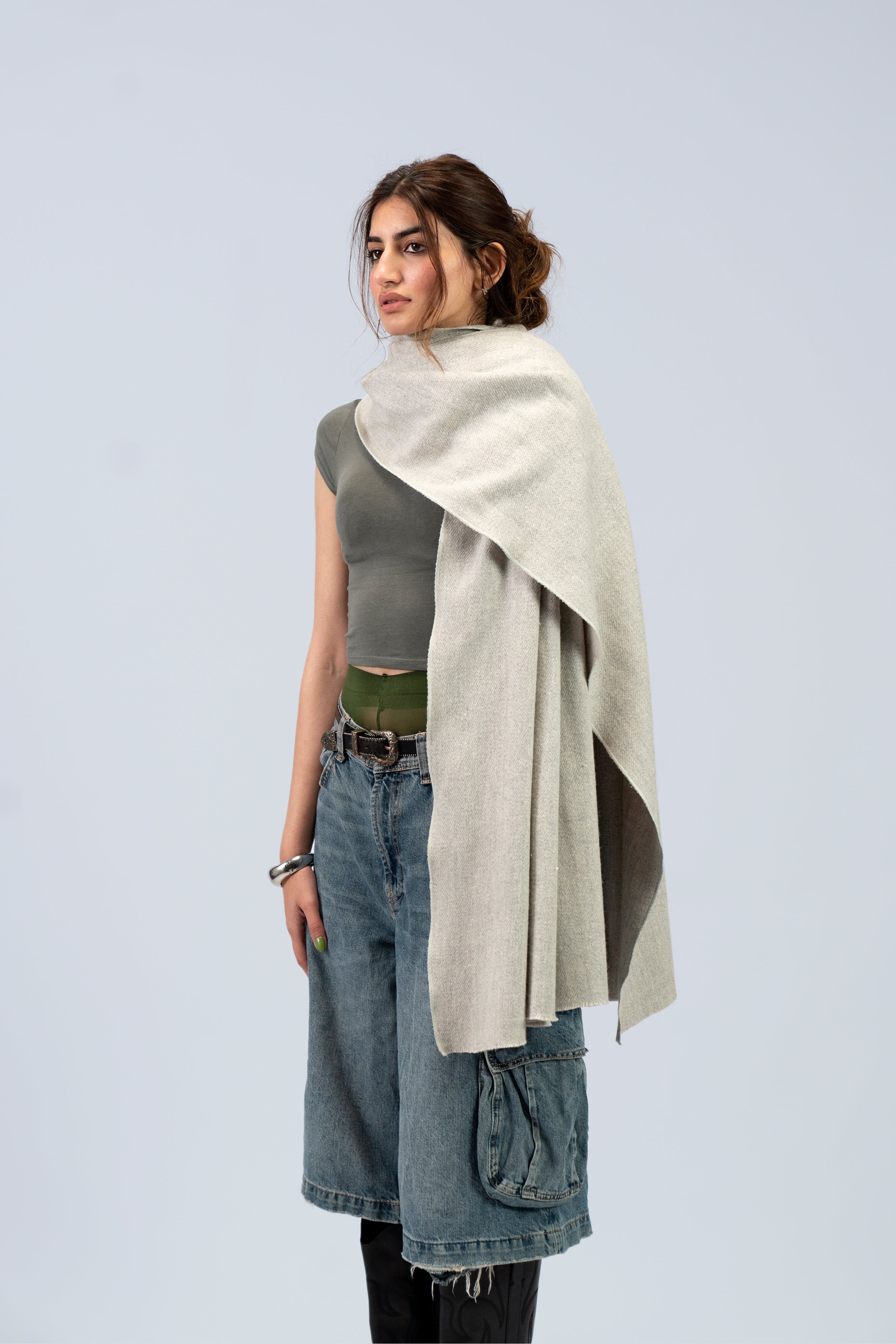 Silver heavyweight lamb wool shawl on female model, three-quarter side view