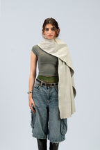 Silver heavyweight lamb wool shawl styled across one shoulder on female model, front view