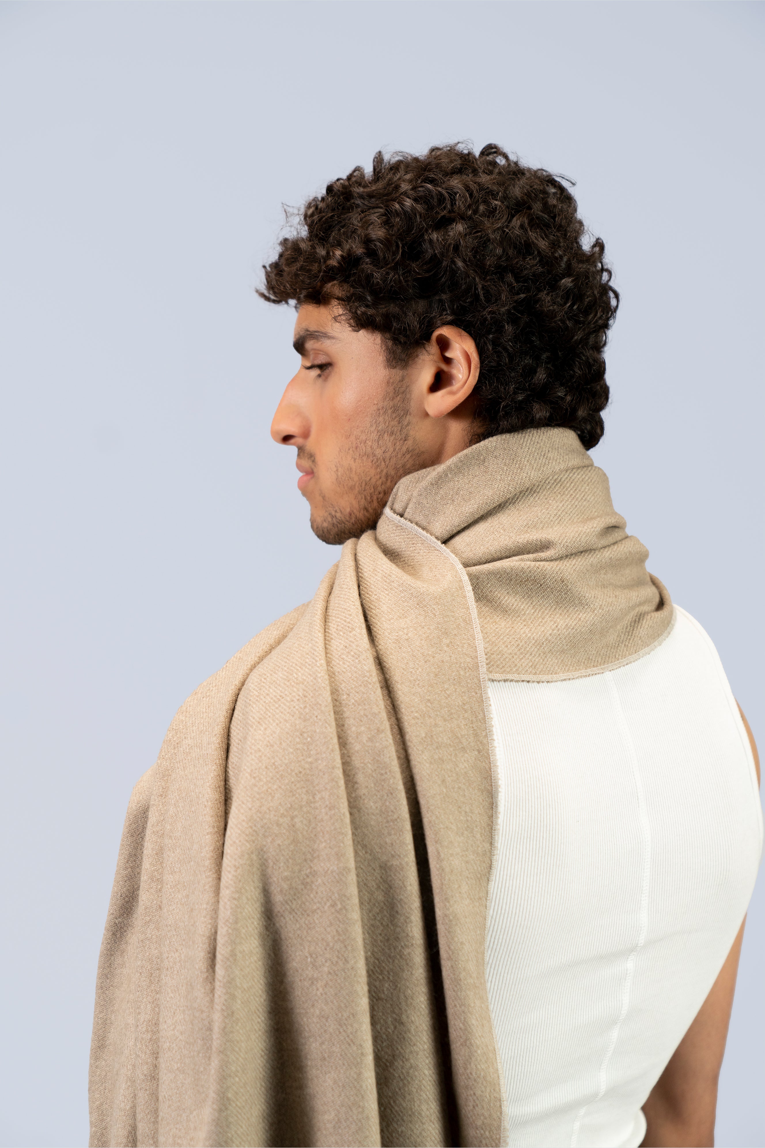 Beige heavyweight lamb wool shawl close-up wrapped at neck, male model side profile