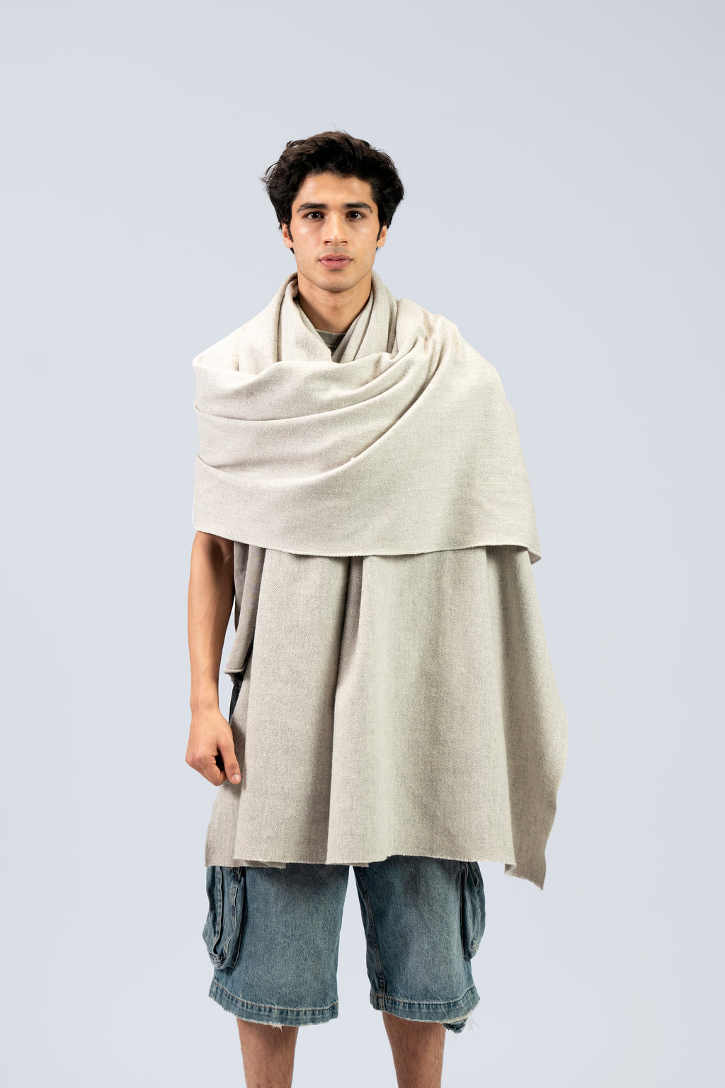 Silver heavyweight lamb wool shawl draped over both shoulders on male model, front view