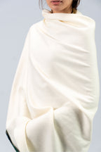 Off-white heavyweight lamb wool shawl close-up of drape across torso on female model