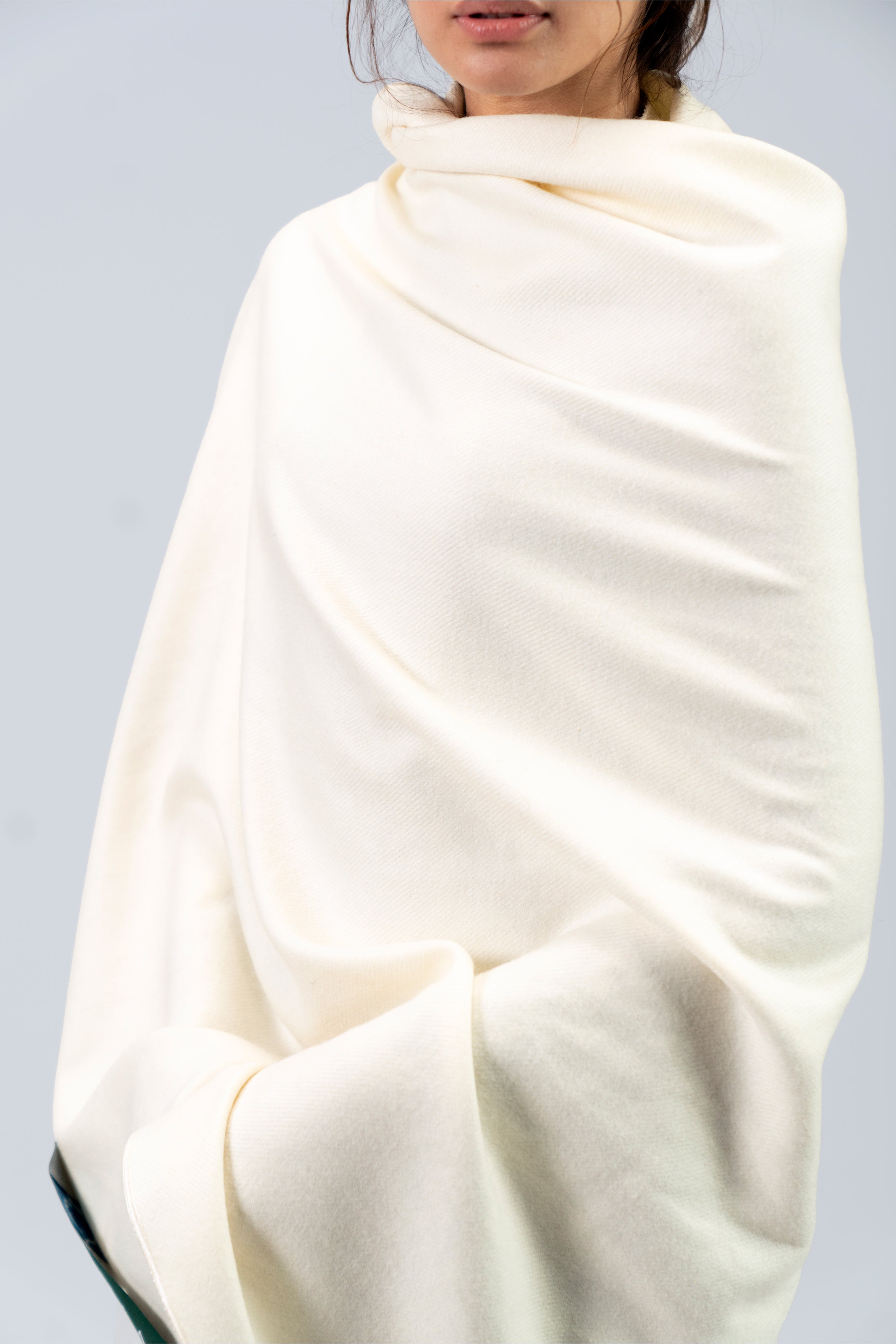 Off-white heavyweight lamb wool shawl close-up of drape across torso on female model