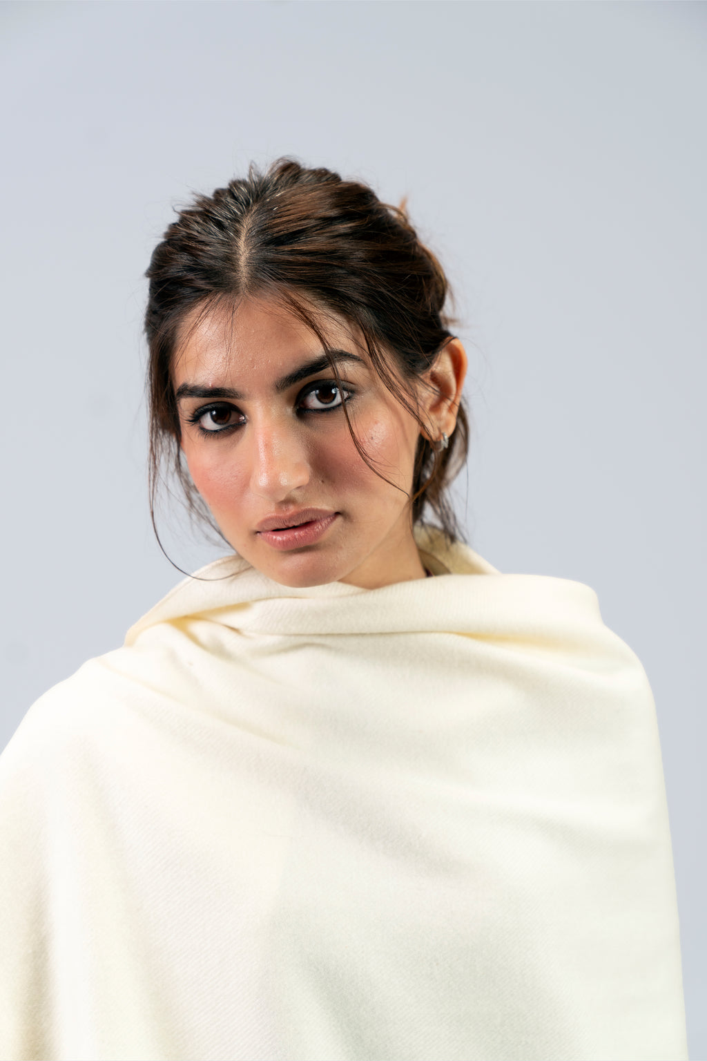 Off-white heavyweight lamb wool shawl close-up portrait on female model, looking over shoulder
