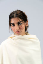Off-white heavyweight lamb wool shawl close-up portrait on female model, looking over shoulder