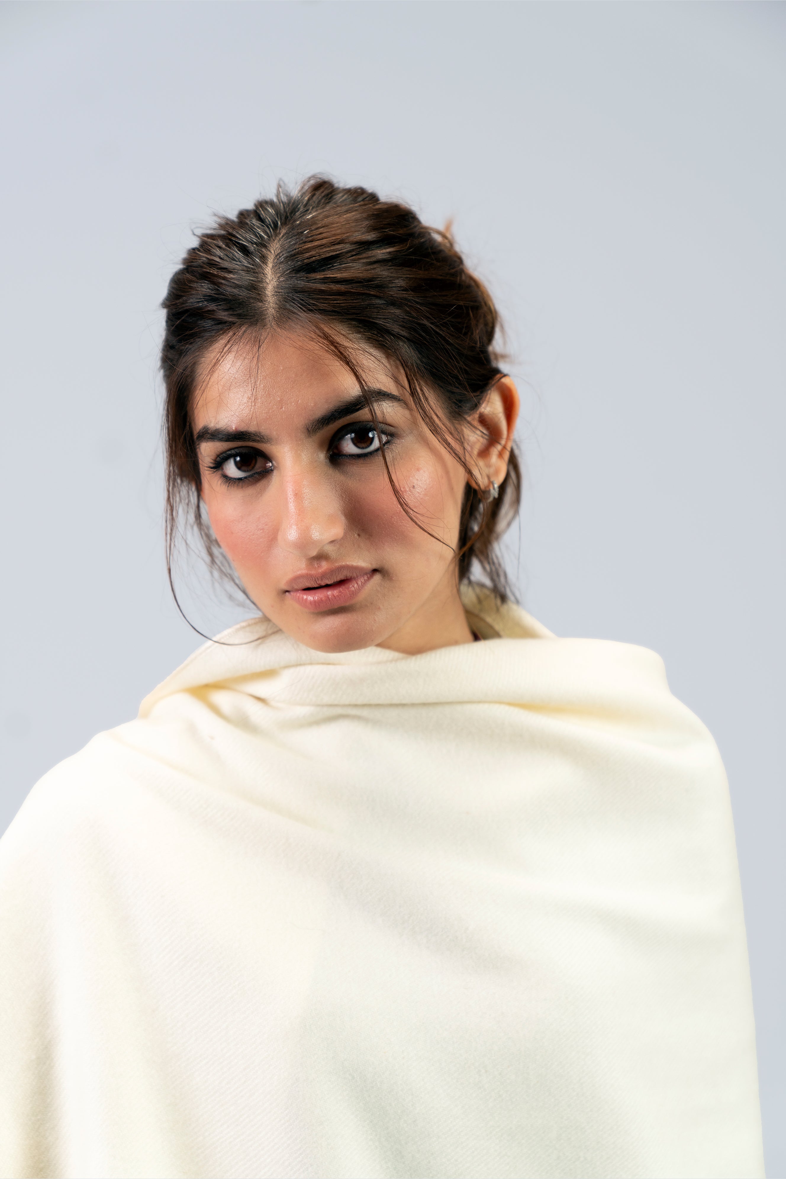 Off-white heavyweight lamb wool shawl close-up portrait on female model, looking over shoulder