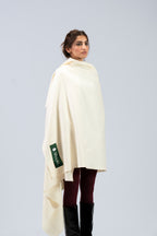 Off-white heavyweight lamb wool shawl on female model, three-quarter side view