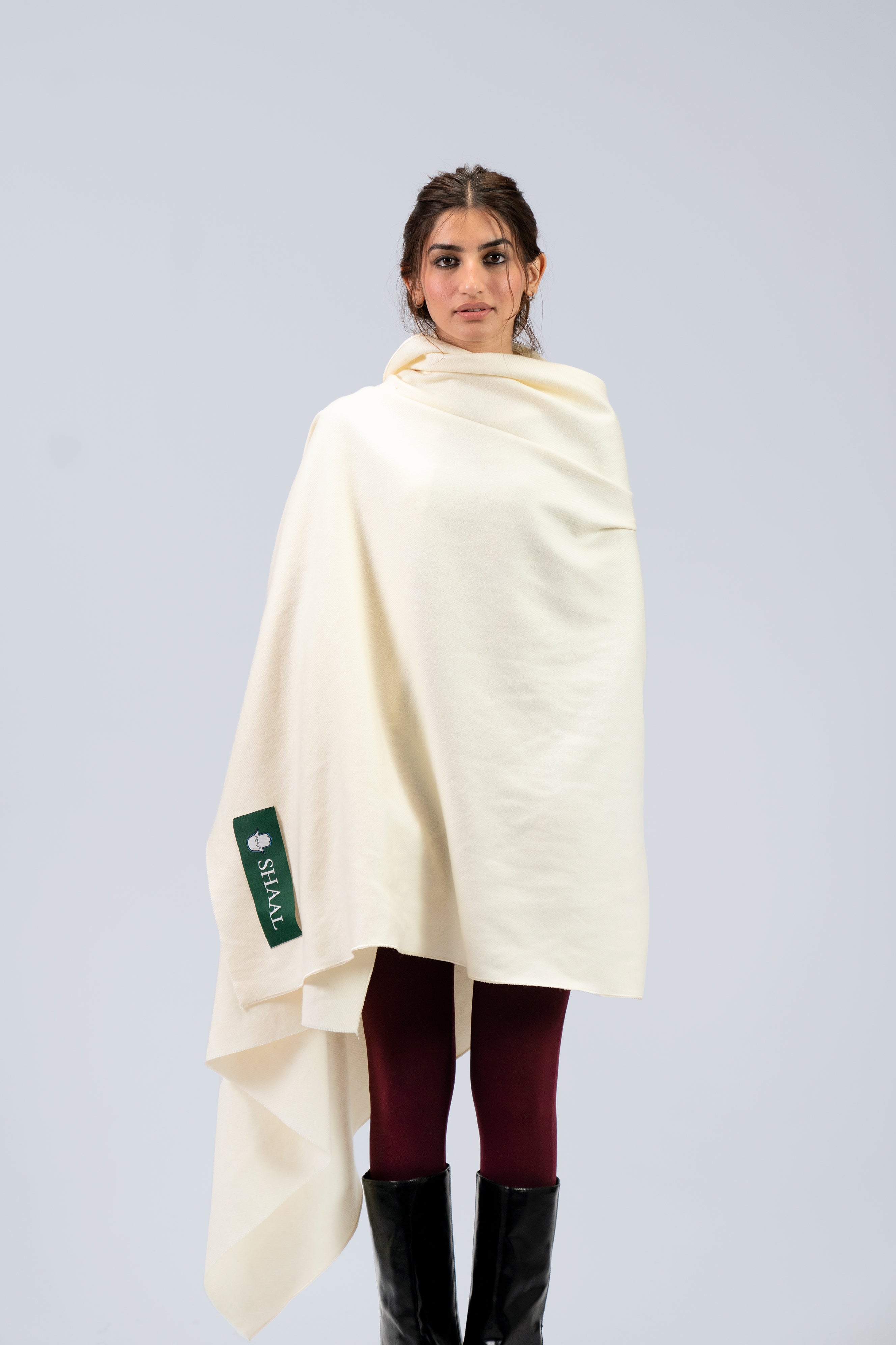 Off-white heavyweight lamb wool shawl wrapped across body on female model, front view