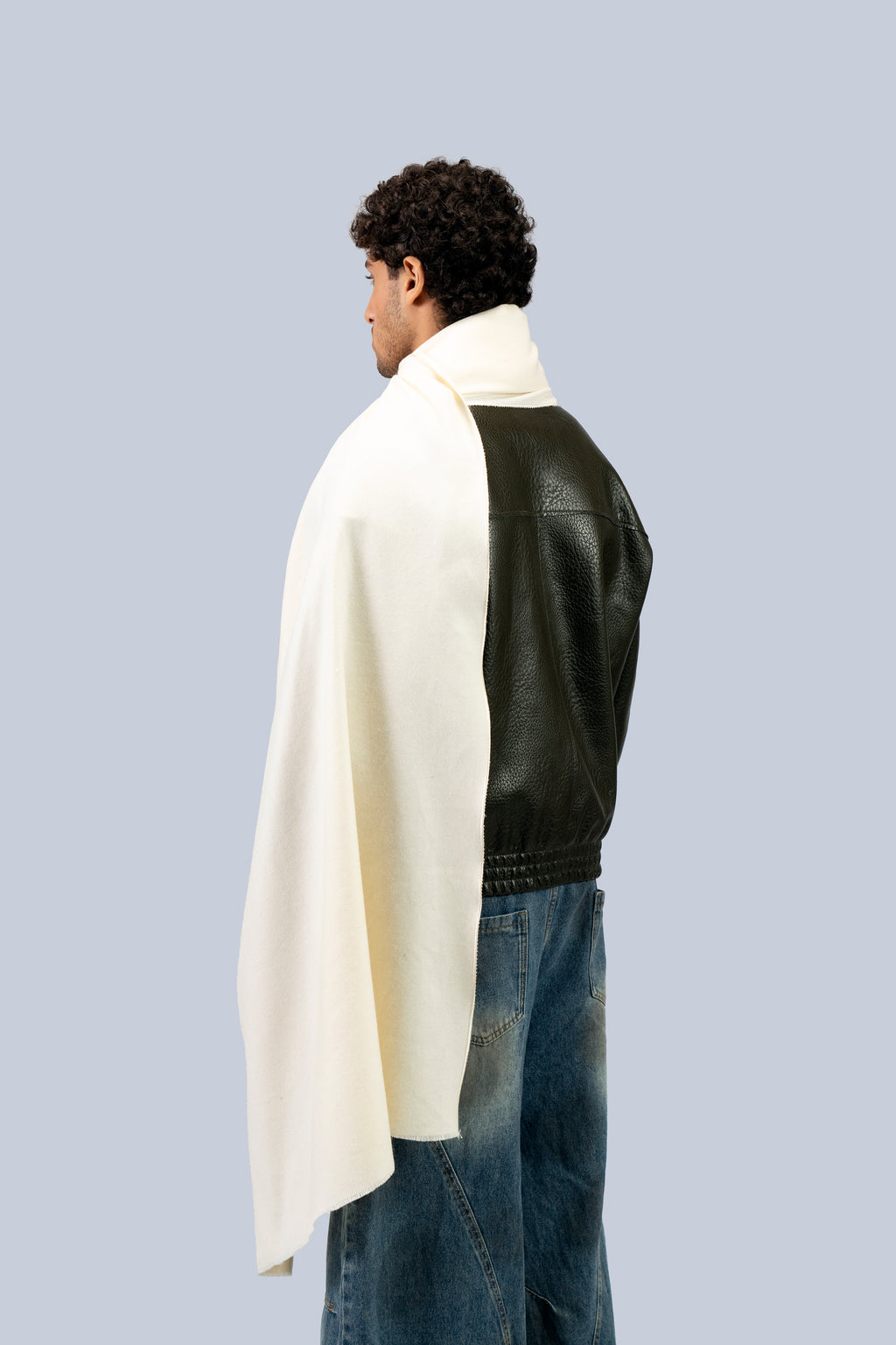 Off-white heavyweight lamb wool shawl from behind on male model in leather jacket, back view