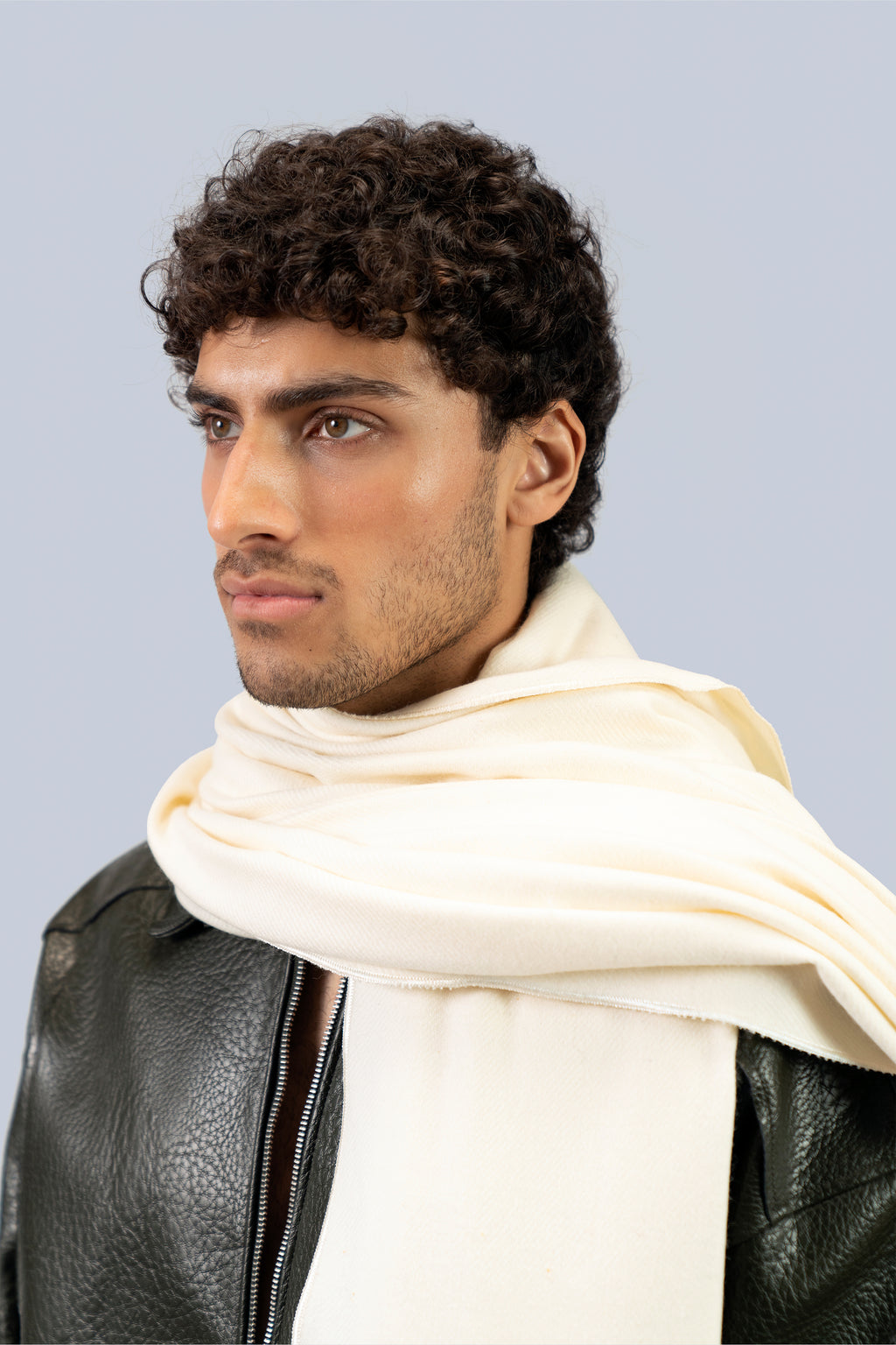 Off-white heavyweight lamb wool shawl close-up wrapped at neck on male model, three-quarter portrait