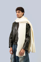 Off-white heavyweight lamb wool shawl over leather jacket on male model, three-quarter side view