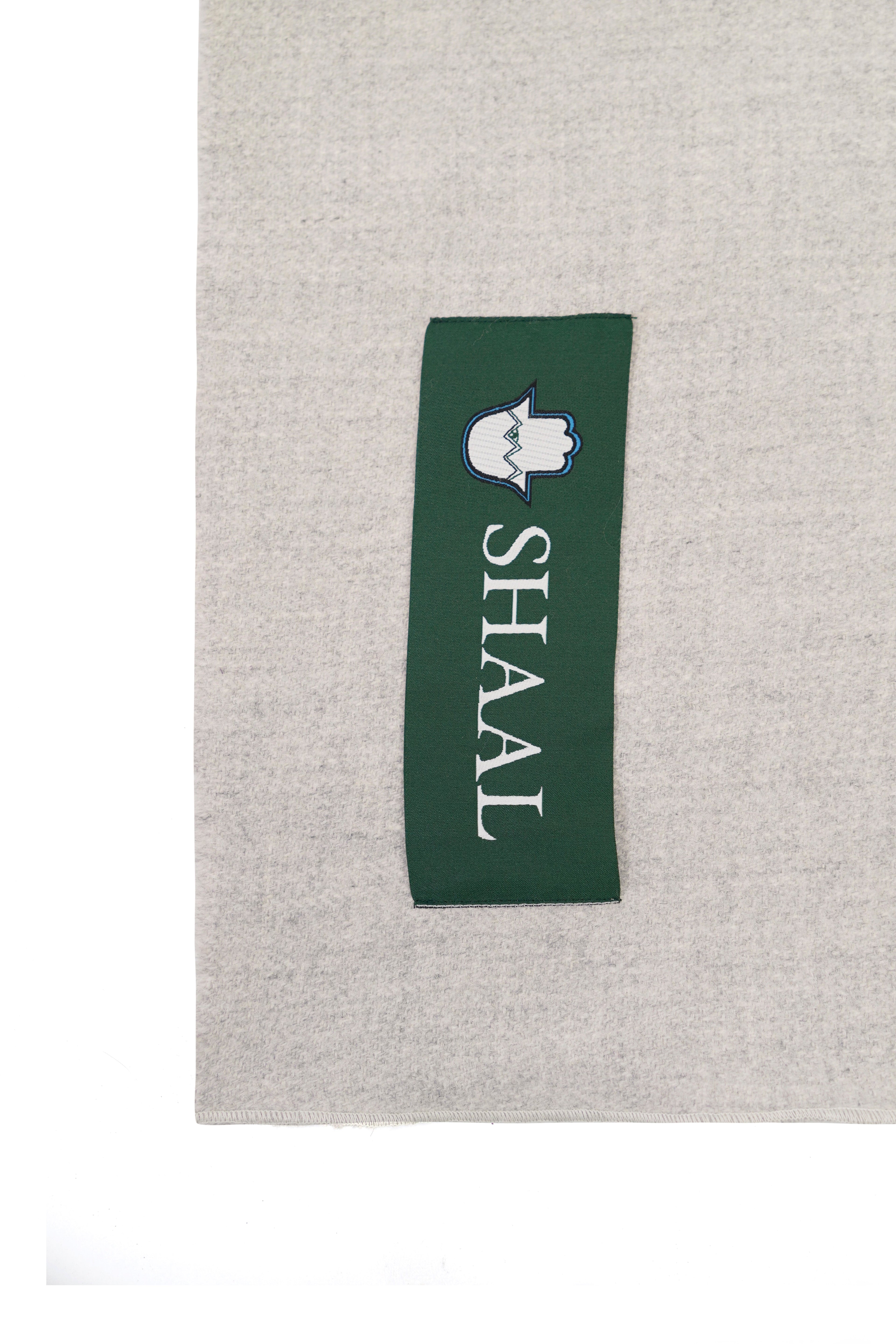 Silver heavyweight lamb wool shawl detail of green SHAAL woven label