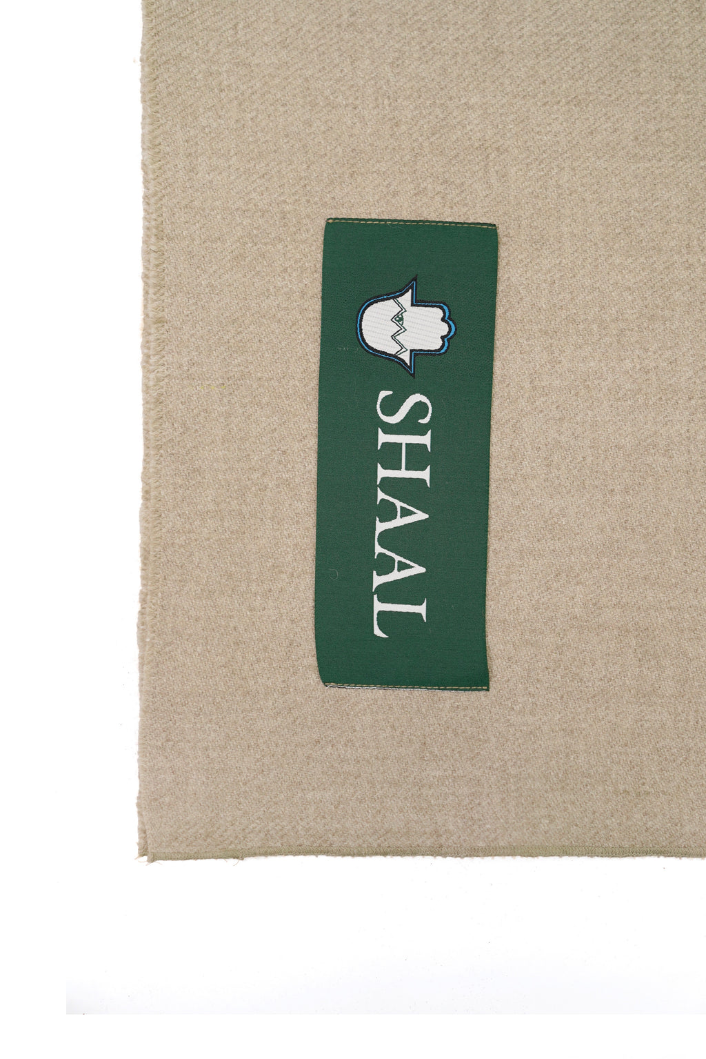 Beige heavyweight lamb wool shawl detail of green SHAAL woven label